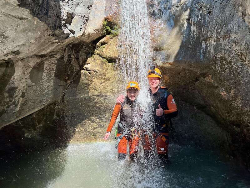 Banff: Beginner Canyoning Half-Day Tour - Entering the gear: thick wetsuits, neoprene socks, and dry bags